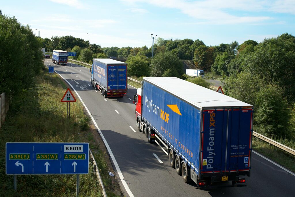 Freight forwarding trucks transporting shipping containers on the highway – B2B Freight Solutions road logistics services